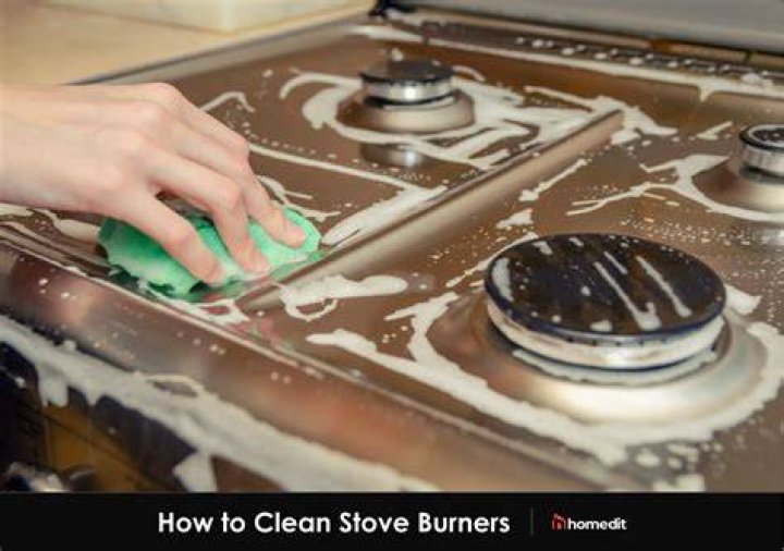 How do you unclog a propane stove burner?